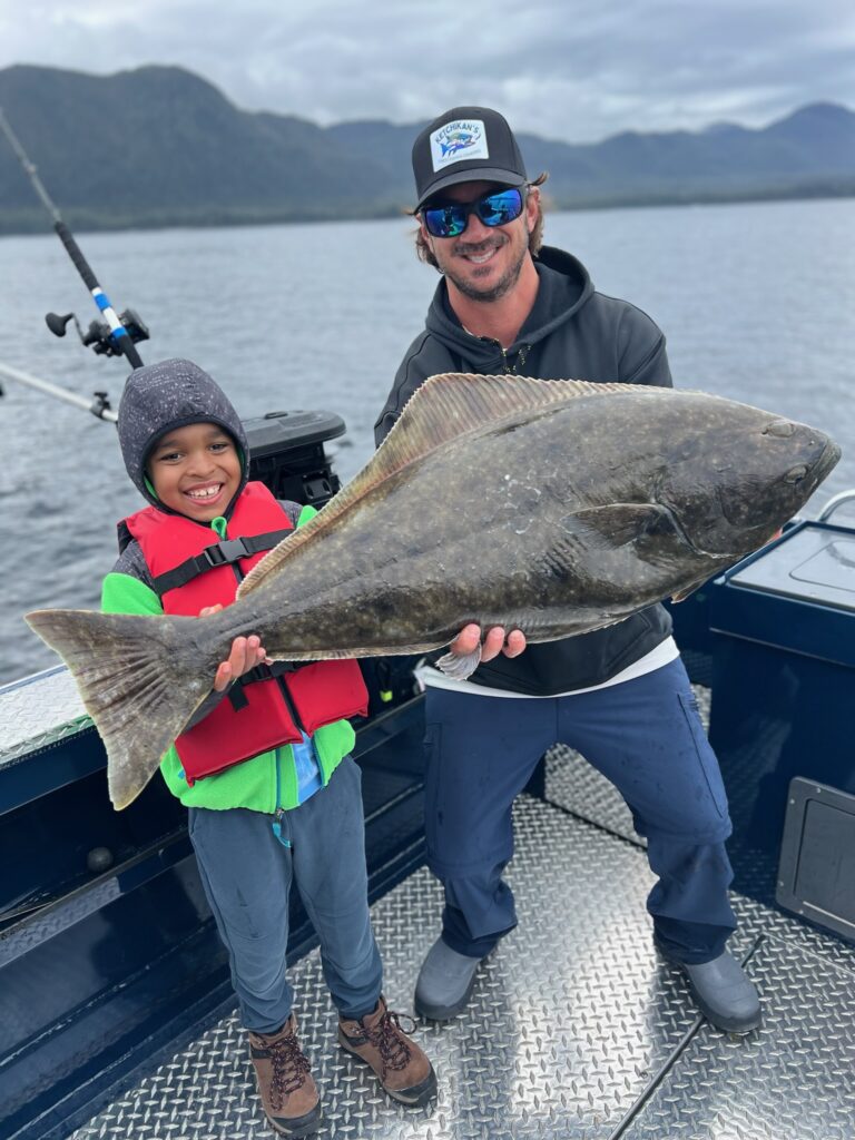 Captain Lukas of Ketchikan Fishing Company holding a massive pacific halibut
